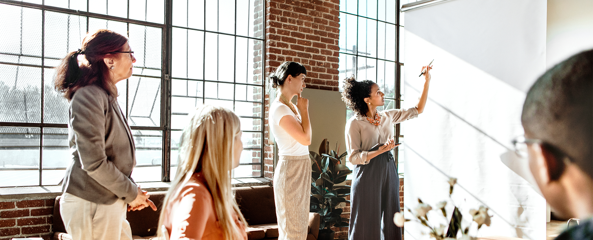 Group of people brainstorming on a whiteboard