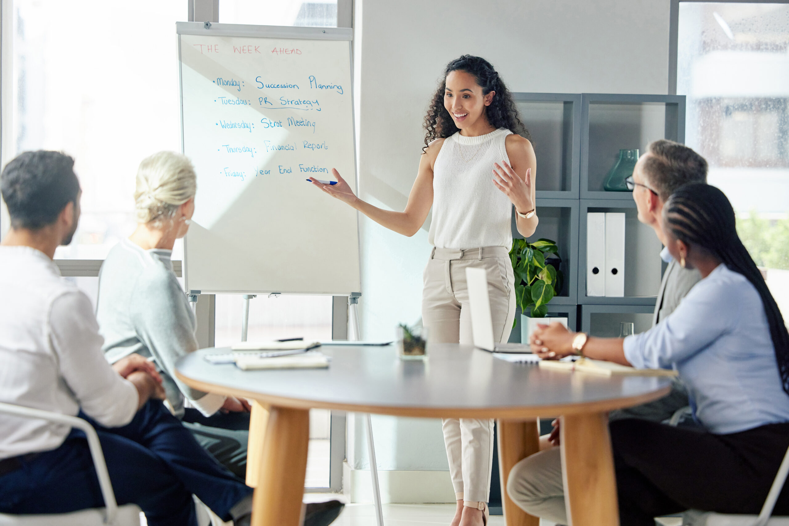A young businesswoman giving a presentation to her colleagues in an office.