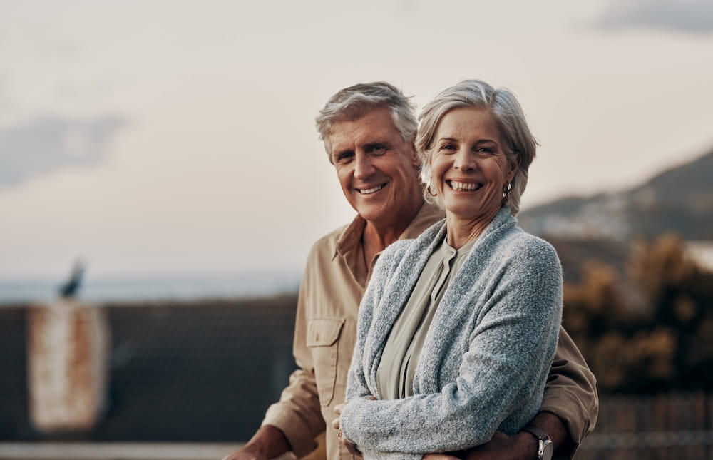 An older couple smile at the camera